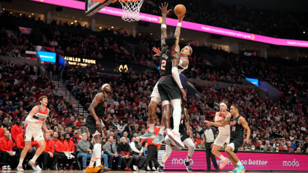 Dec 21, 2023; Portland, Oregon, USA; Washington Wizards small forward Kyle Kuzma (33, behind) shoots the ball over Portland Trail Blazers center Deandre Anton (2) during the first half at Moda Center. Mandatory Credit: Soobum Im-USA TODAY Sports